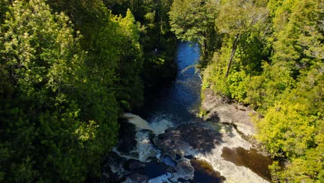 Aerial-view-dolly-in-of-pools-in-the-Rio-Bravo-of-Tepuhueico-Park,-Chiloe-Chile,-hidden-in-a-lush-forest