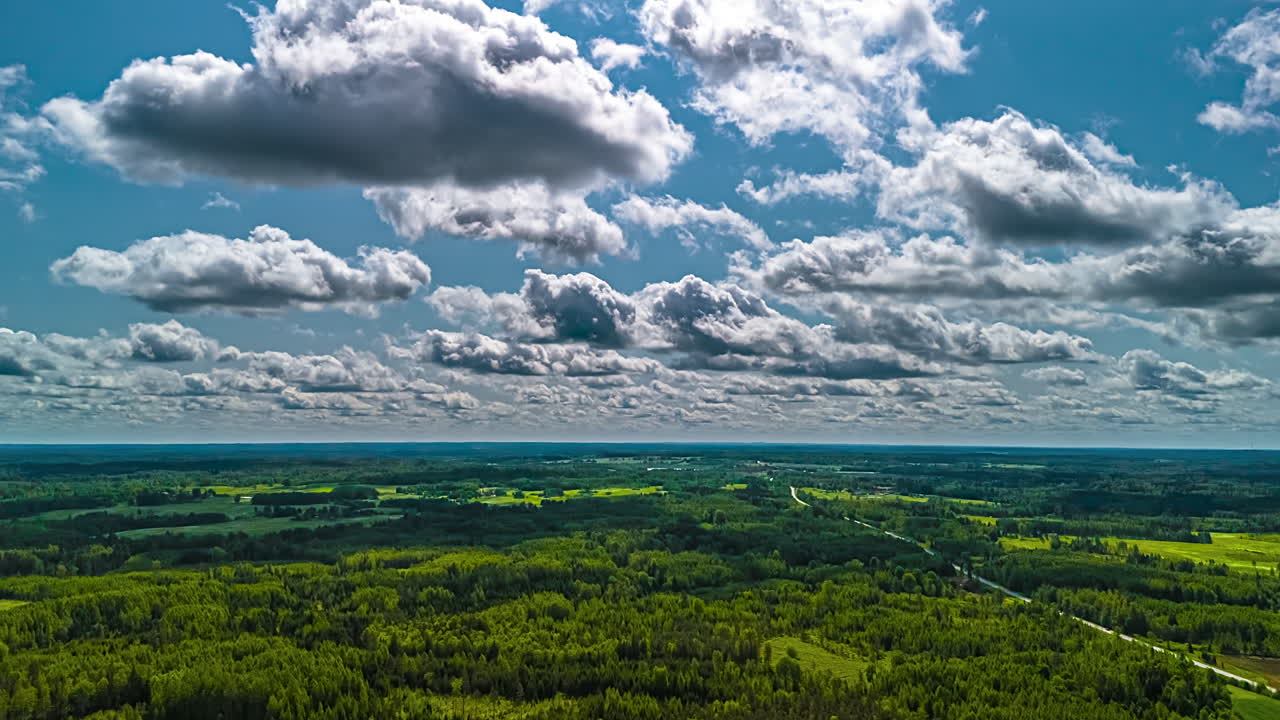 Hyperlapse of lush green landscape under a cloudy blue sky