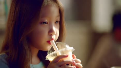 child drinking bubble tea