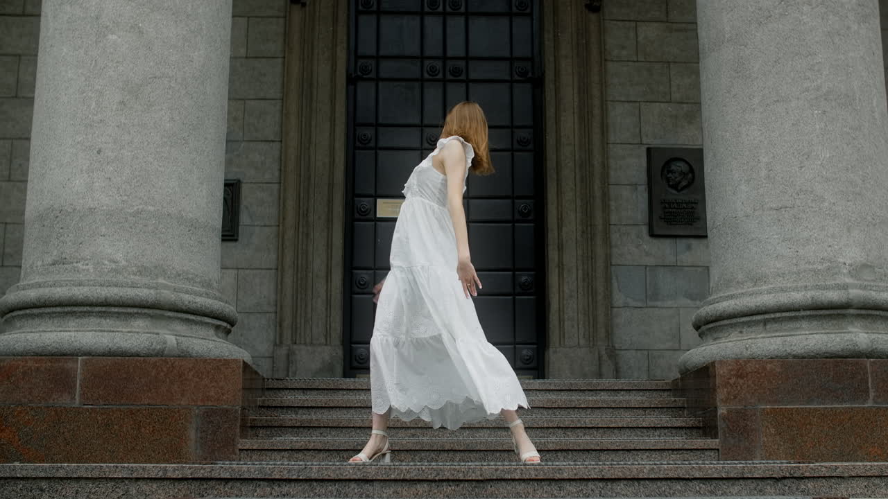 Woman Dancing in Front of a Building