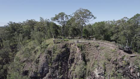 Woman-At-The-Wallaman-Falls-Lookout-Waving-Hands-In-The-Air