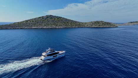 a yacht cruising past the island of kornati in a serene blue sea, aerial view