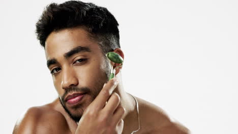 face, beauty and man with facial roller