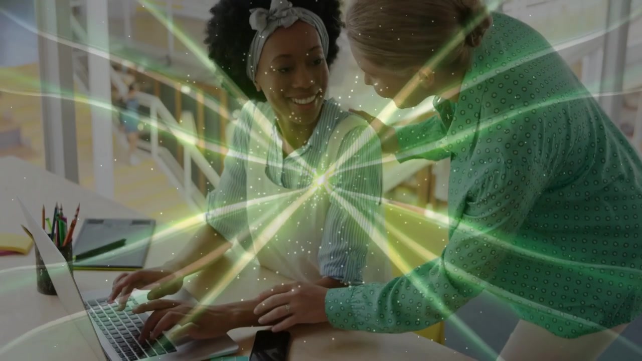 Vertical video: Diverse female pair, mentor coming, guiding typing at desk on laptop green overlay