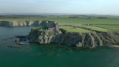 An-aerial-view-of-the-inside-and-side-of-Tantallon-Castle-ruin-on-a-sunny-day,-East-Lothian,-Scotland