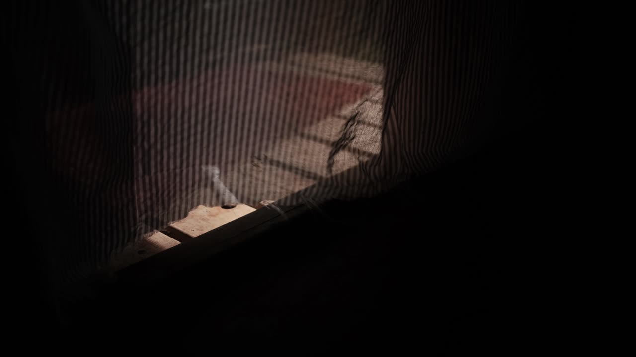 View through a doorway covered with a sheer curtain, revealing the wooden deck of a small children’s treehouse, evoking warmth, calmness, and nostalgic outdoor play