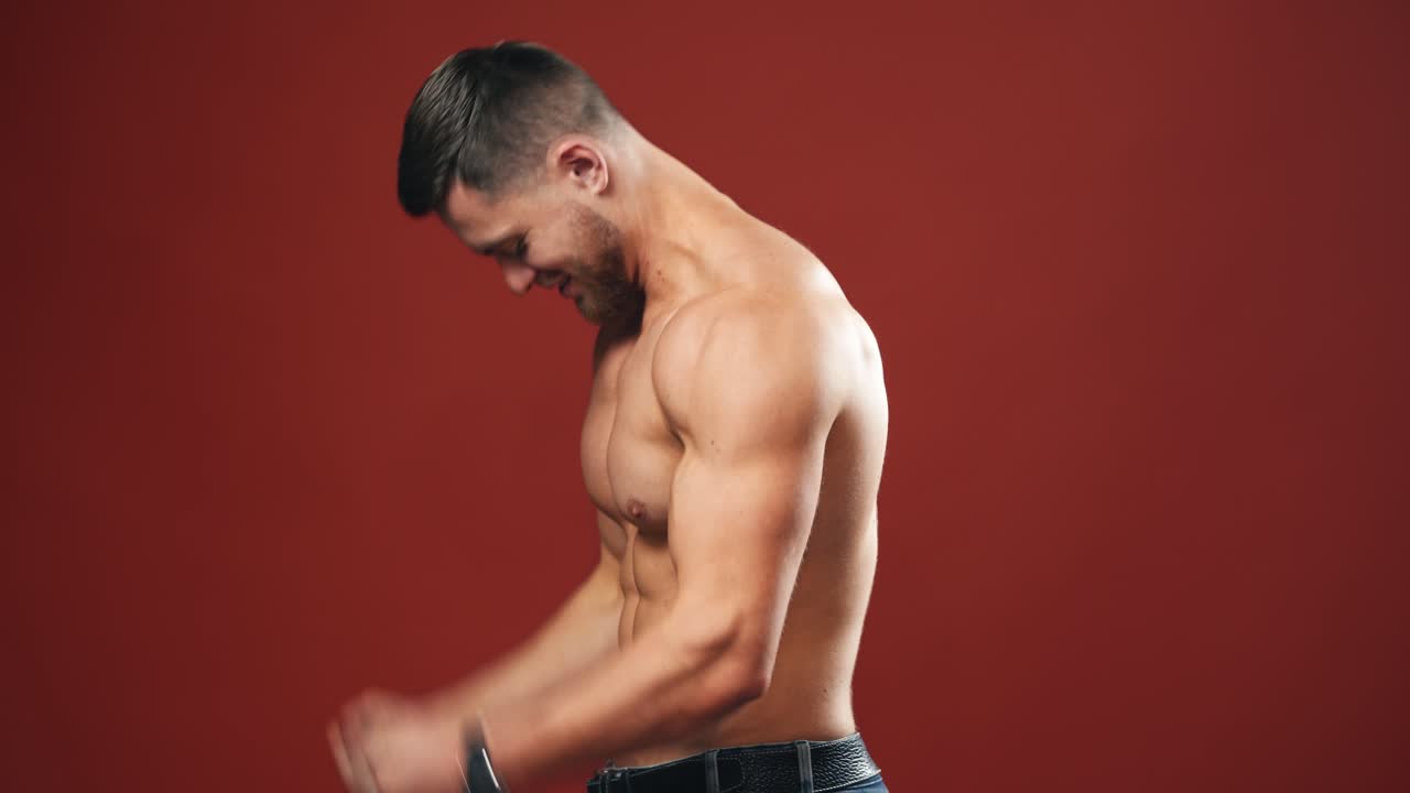Male flexing his muscles. Muscular model young man on background