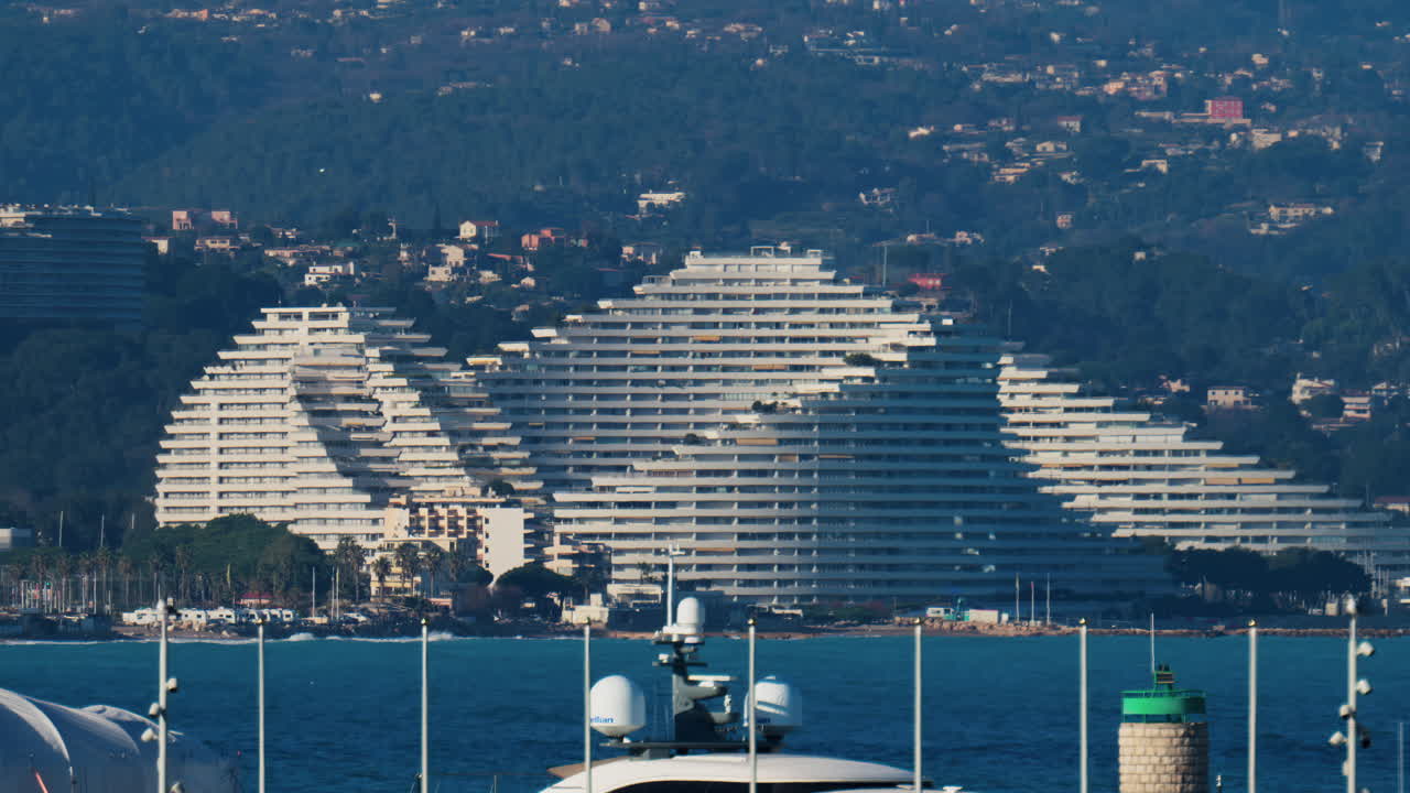 Villeneuve-Loubet, France - March 9, 2025: Distant view of the Marina Baie des Anges with the mountains on the background
