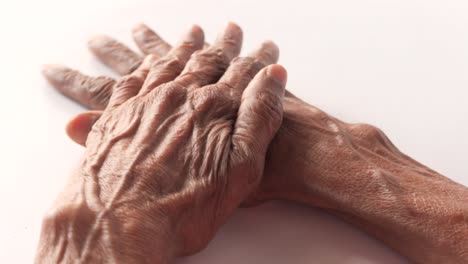 close-up of elderly hands showing wrinkles and veins