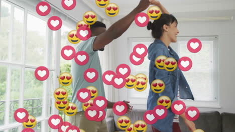 animation of emoji icons over diverse couple dancing