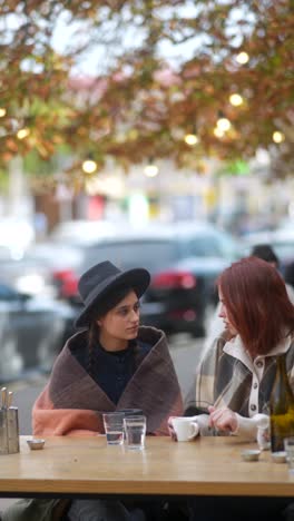 two women relaxing in an outdoor cafe