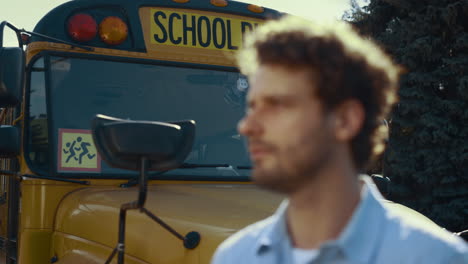 Portrait-schoolbus-driver-face-look-in-distance.-School-bus-standing-on-parking.
