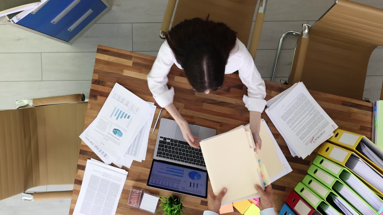 Overhead view of a woman working at her office desk