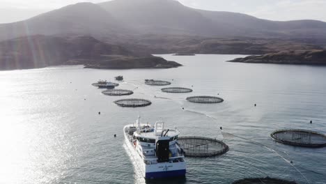 Wide-drone-shot-of-a-well-boat-and-a-fish-farm-near-the-Isle-of-Uist