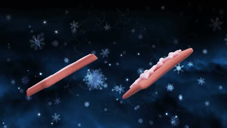 Animation-Von-Weihnachtslebkuchenplätzchen-über-Schneeflocken,-Die-Auf-Blauen-Hintergrund-Fallen