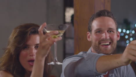 young adult friends make a toast at a house party, close up, shot on r3d