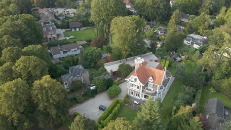 jib up of beautiful mansion and revealing a stunning wealthy neighborhood