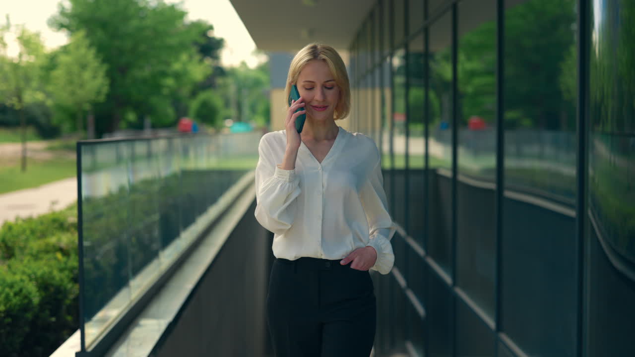 Businesswoman Walking and Talking on Phone