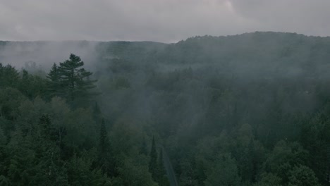 Drone-flying-through-a-beautiful-foggy-mountain-top-landscape,-forward-slight-turn-left