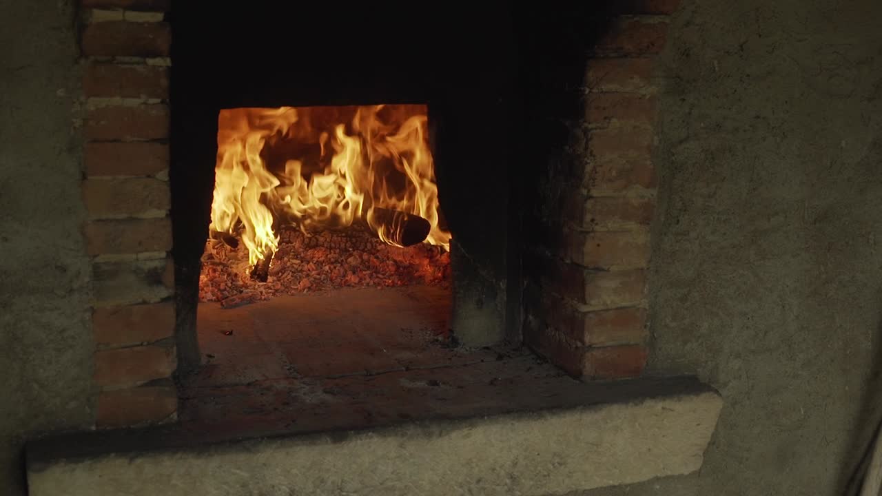 Burning Wood Fire Inside Traditional Brick Oven