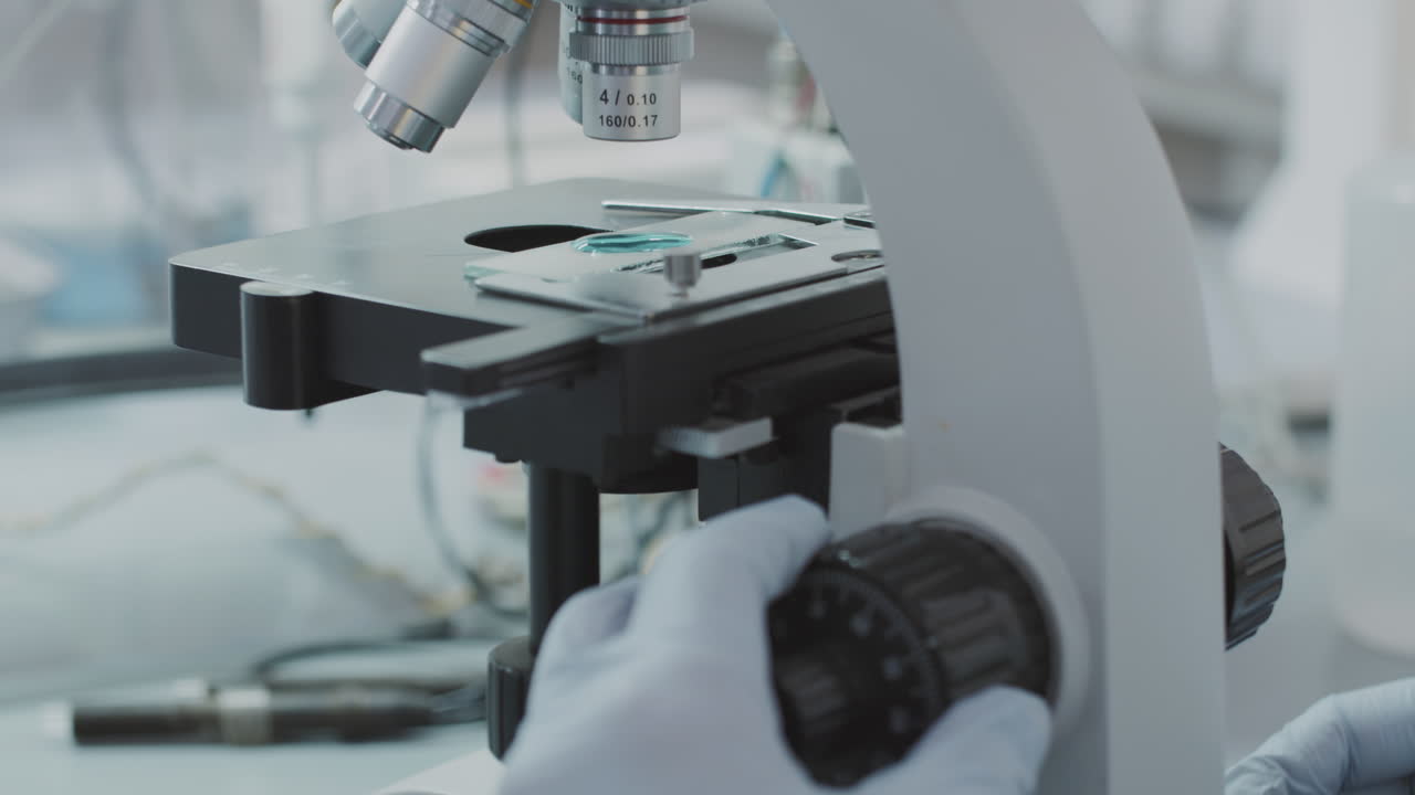 Unrecognizable Chemist Using Microscope