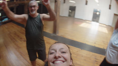 Dance-teacher-circling-around-and-recording-video-with-dancers