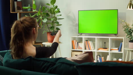 woman watching tv on green screen