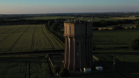 Aerial-footage-of-a-water-tower-on-a-summers-evening