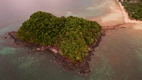 aerial orbit around rocky basalt island off shore of el nido palawan