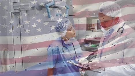 Animation-of-flag-of-usa-over-diverse-surgeons-in-hospital