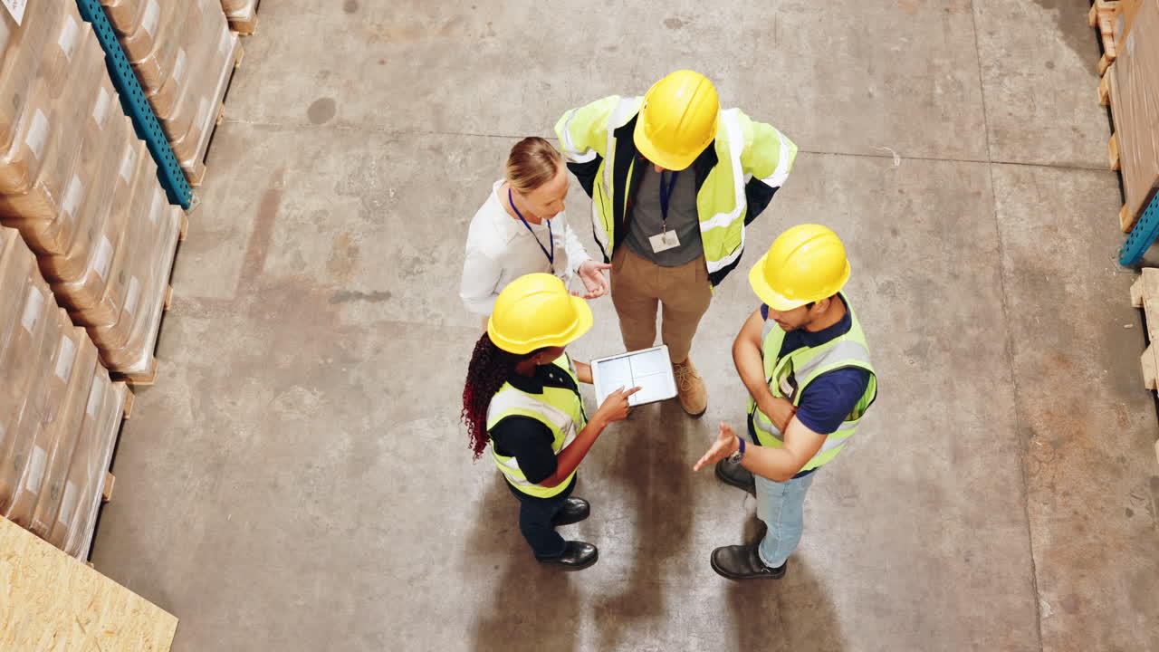 Warehouse workers collaborating with a tablet