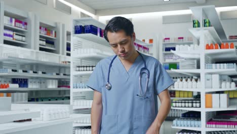 tired asian male doctor with stethoscope standing in pharmacy
