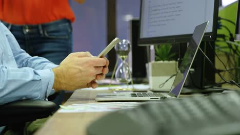 executive using mobile phone at desk in office 4k