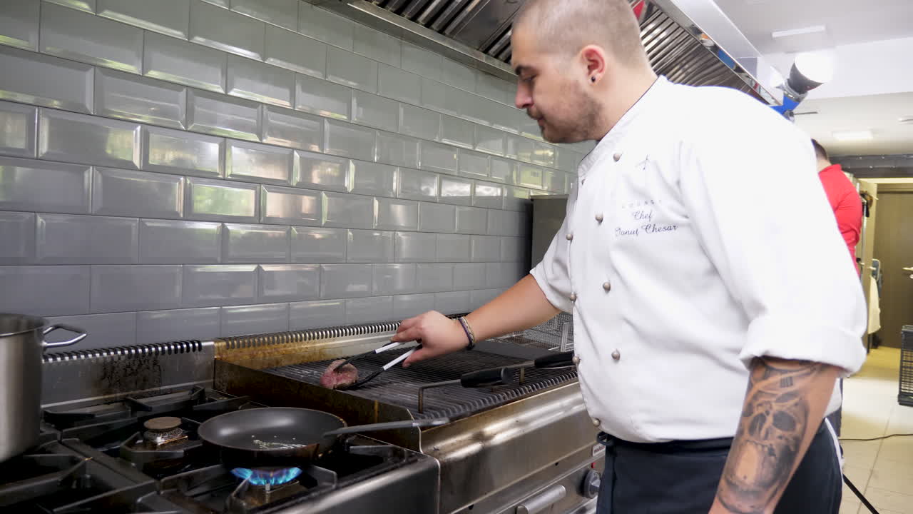 Chef Cooking Meat in a Professional Kitchen