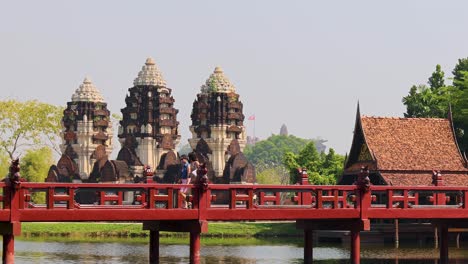 time-lapse of a temple across a red bridge