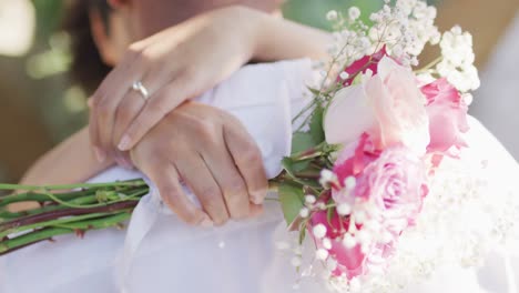 close up of married african american couple embracing with flowers
