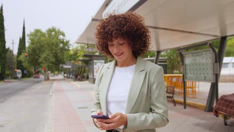 businesswoman talking on phone at bus stop
