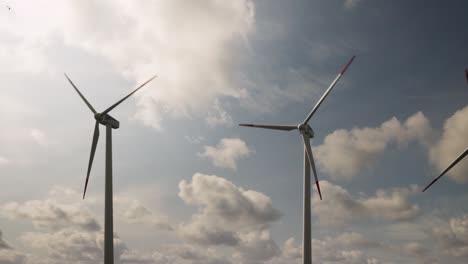 3d wind farm with green field in the background. alternative renewable energy generation. environmental conservation concept. realistic 3d animation wind turbines