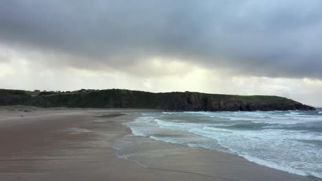 View-of-rough-sea-along-Playa-de-Xago-on-cloudy-day,-Spain