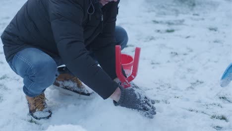 grandfather and granddaughter having fun in the snow