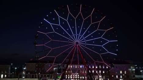 ferris wheel with glowing multicolored lights against the night sky.