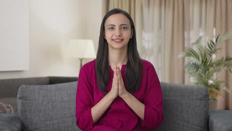 happy indian woman waving doing namaste