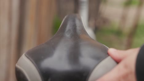 woman cleaning bicycle seat - close up shot