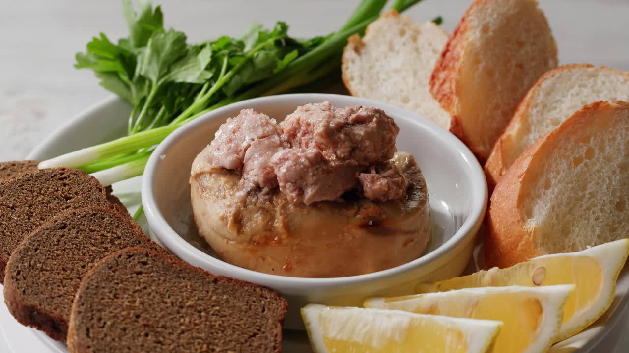 Smoked cod liver in oil in open tin can with fresh greens on wooden table. Seafoods delicacy. High quality 4k footage