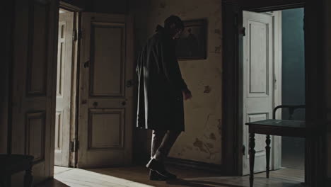 man walking through an old house