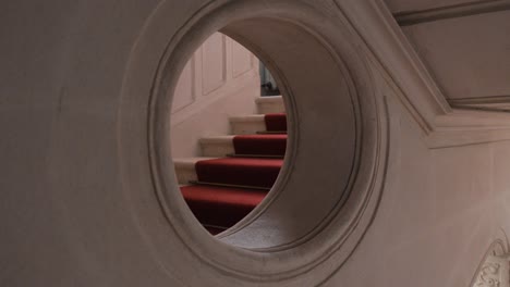 slow orbiting shot of stairs through a window within a chateau de pouzilhac