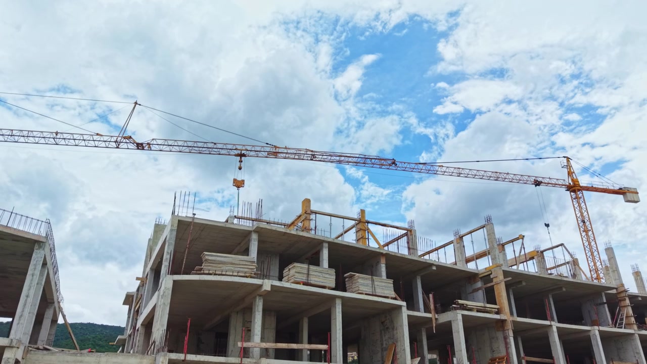 Rough concrete framework reveals bustling infrastructure advancement. Rudimentary concrete structure amidst sky signifies active urban growth and construction efforts