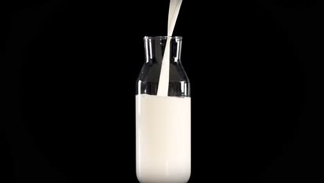 milk being poured into a glass bottle