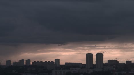 city skyline under a stormy sunset