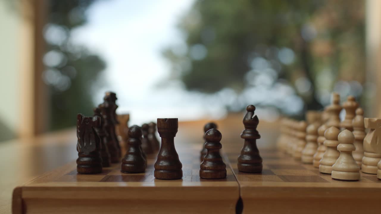 Chess rook moved on board; strategy game with calm atmosphere